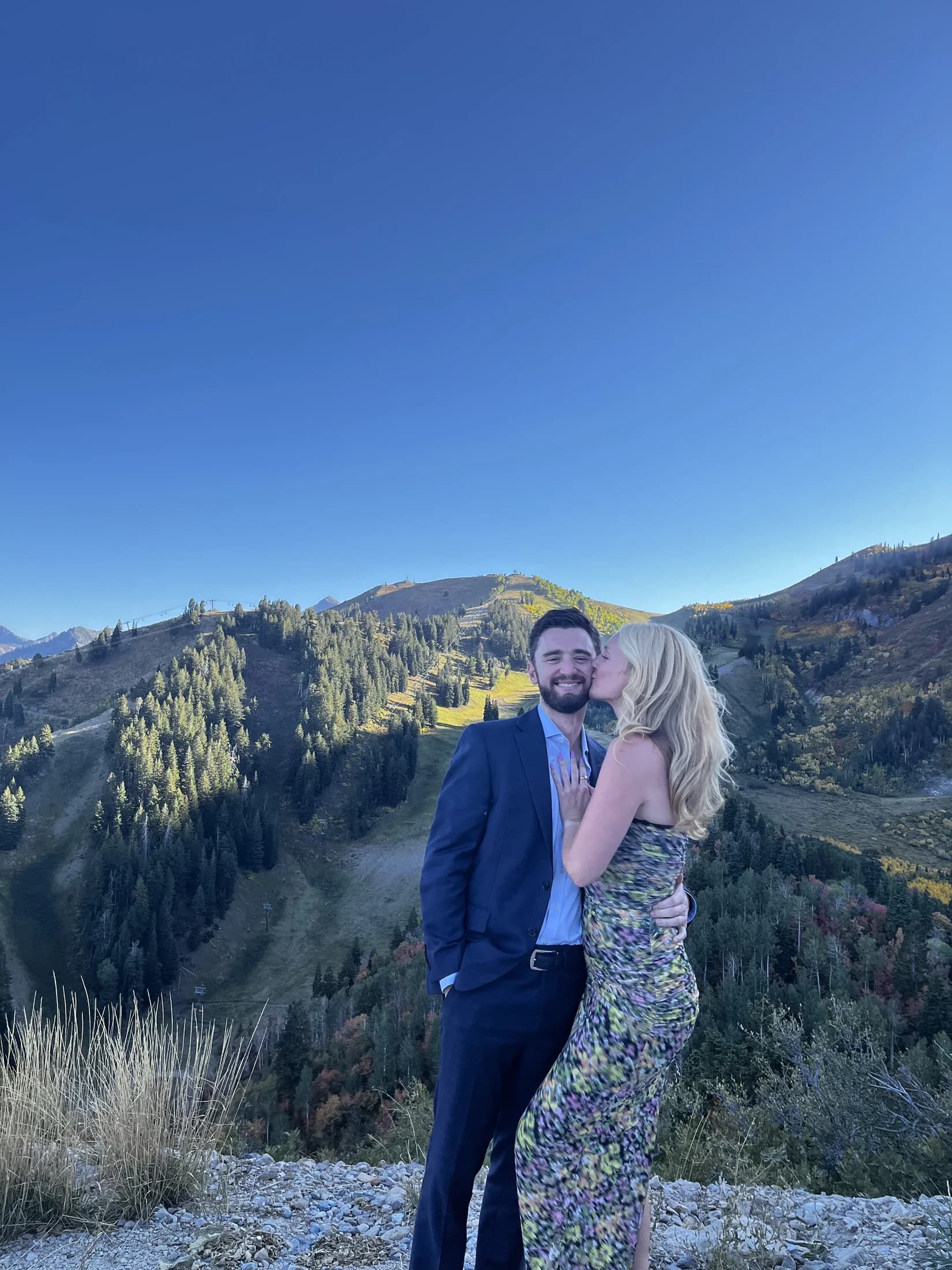 Molly kissing Mitch on a mountain overlook