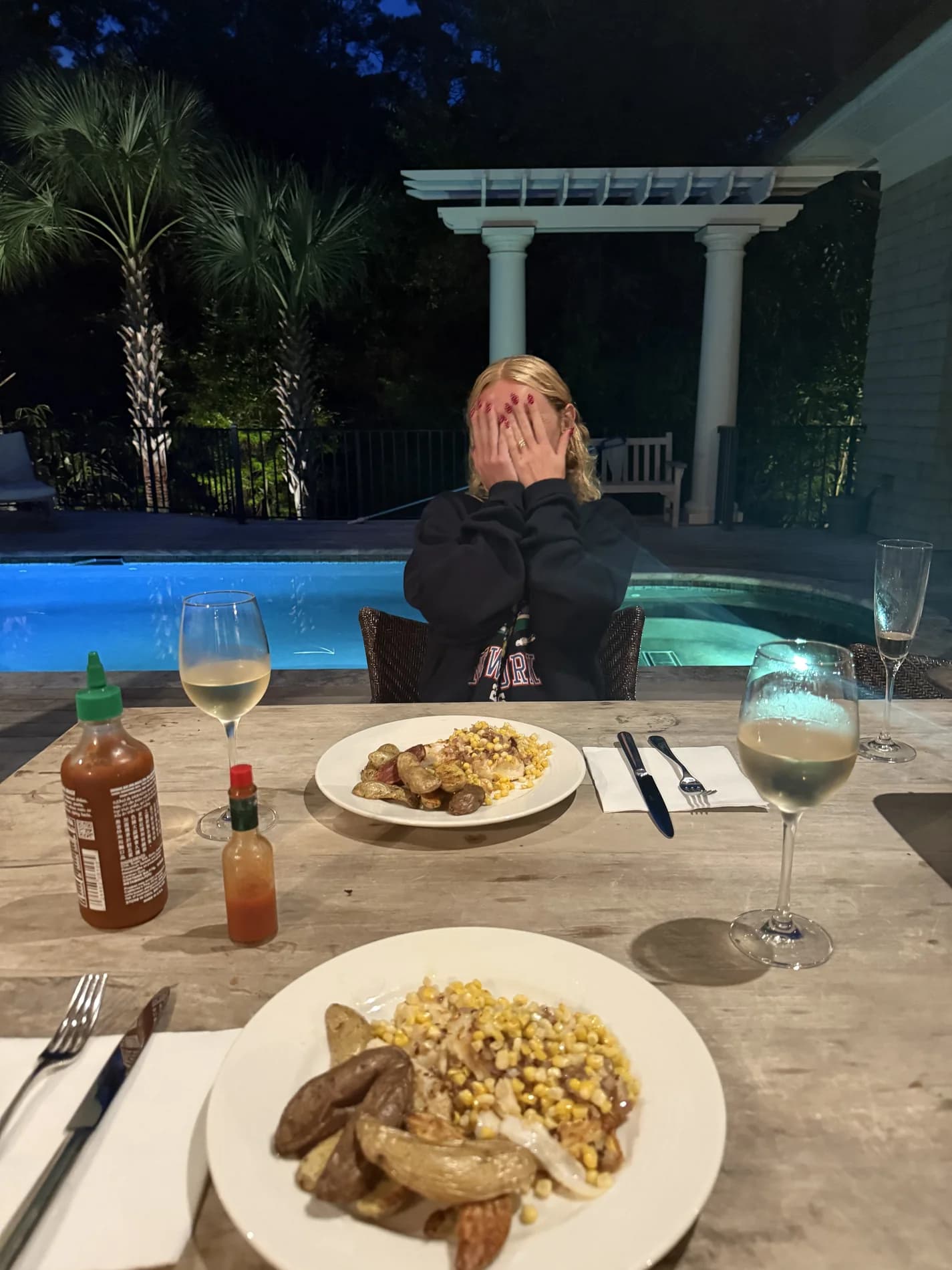Molly laughing at a poolside dinner