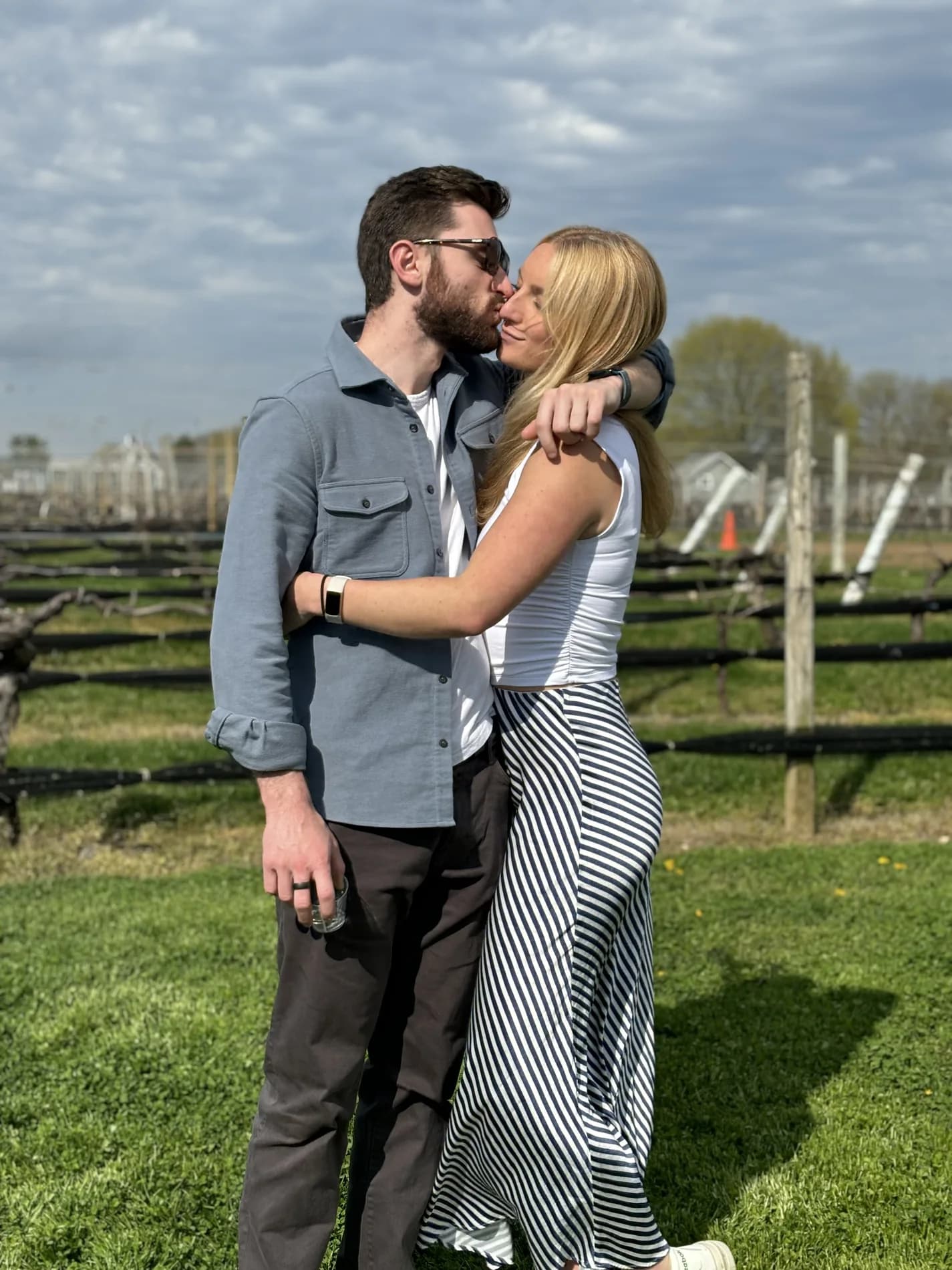 Mitch kissing Molly in a vineyard